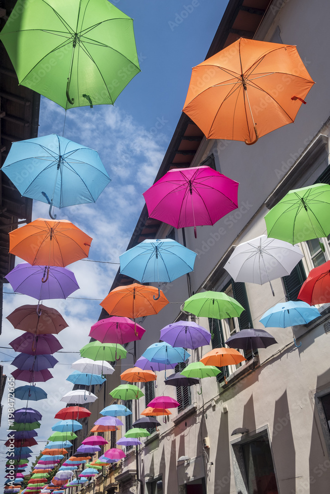 Pietrasanta, Lucca: the main street with colorful umbrellas
