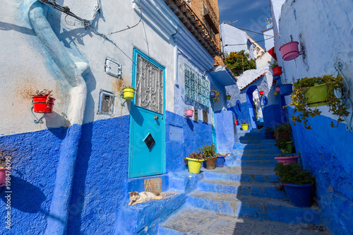 Blue street with color pots in Chefchaouen © Kokhanchikov