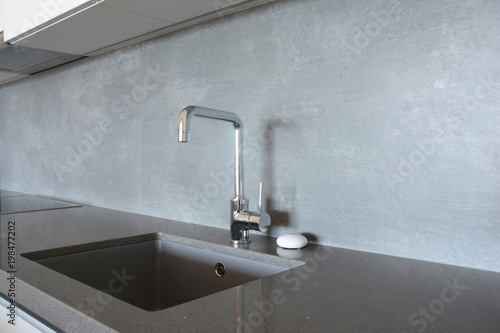 Modern kitchen metal faucet and ceramic kitchen sink.