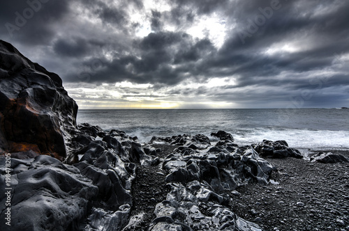 Amazing rock formations made by erstwhile flowing lava on a black sand beach in Iceland