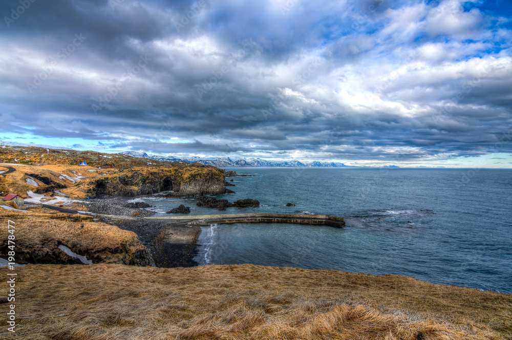 A beautiful Icelandic landscape and sea with a dramatic cloudscape in mid march
