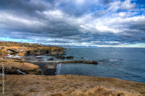 A beautiful Icelandic landscape and sea with a dramatic cloudscape in mid march