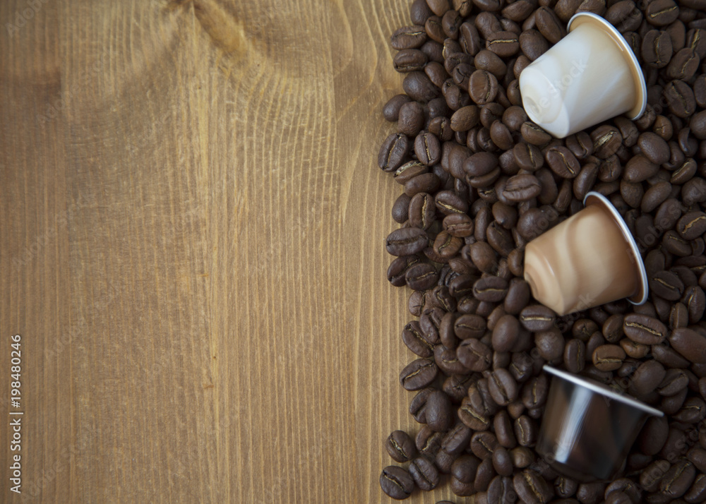 Coffee Beans and Capsules on Wooden Background Texture Top View Copy Space Coffee Beans and Capsules on Wooden Background Texture Top View Copy Space