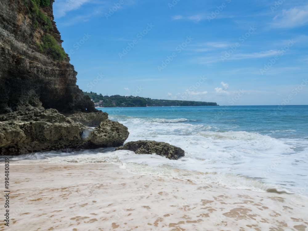 Azure beach with clear water of Indian ocean at sunny day A view of a cliff in Bali, Indonesia