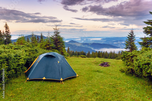 tent on the green grass in the mountains
