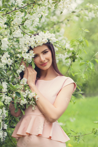 Beautiful Brunette Fashion Model Woman with Flowers Outdoor © millaf
