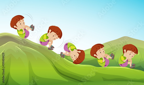 Boy rolling down the hill