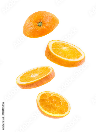 sliced flying orange isolated on white background. cut orange in pieces isolated on white background. Levity fruit floating in the air.