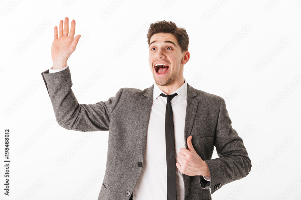 Cheerful business man holding jacket and waving his palm Cheerful business man holding jacket and waving his palm