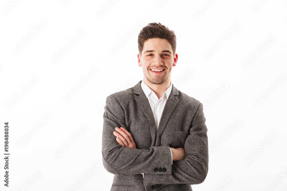 Smiling business man with crossed arms looking at the camera Smiling business man with crossed arms looking at the camera