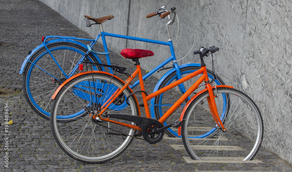 A pair of bicycles parked in the city