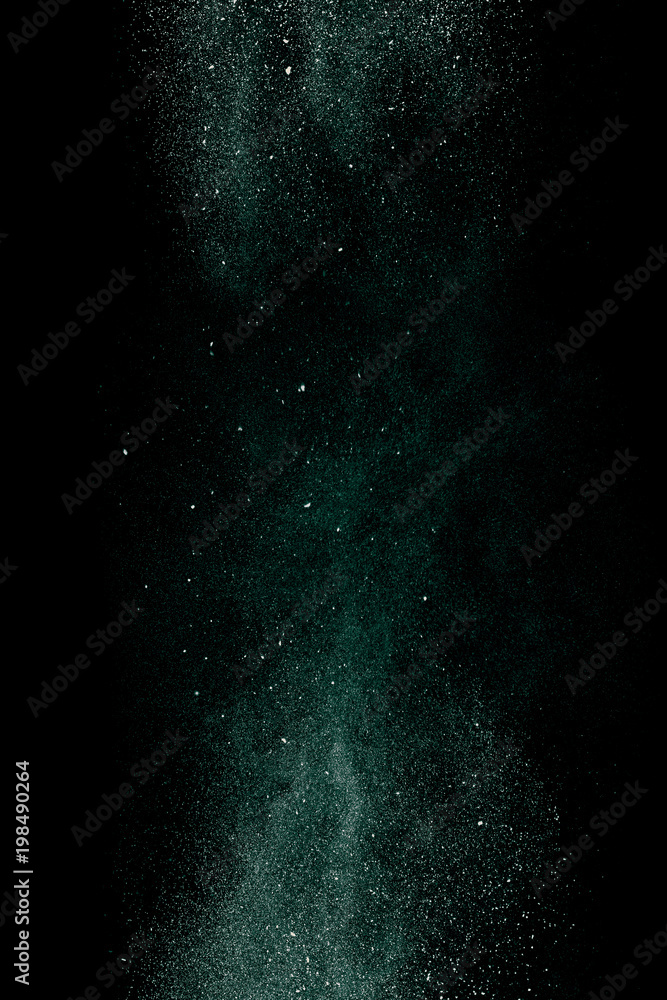 Green dust on a black background. Fine particles in motion.