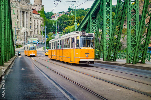 Freedom Bridge and yellow train in Budapest.