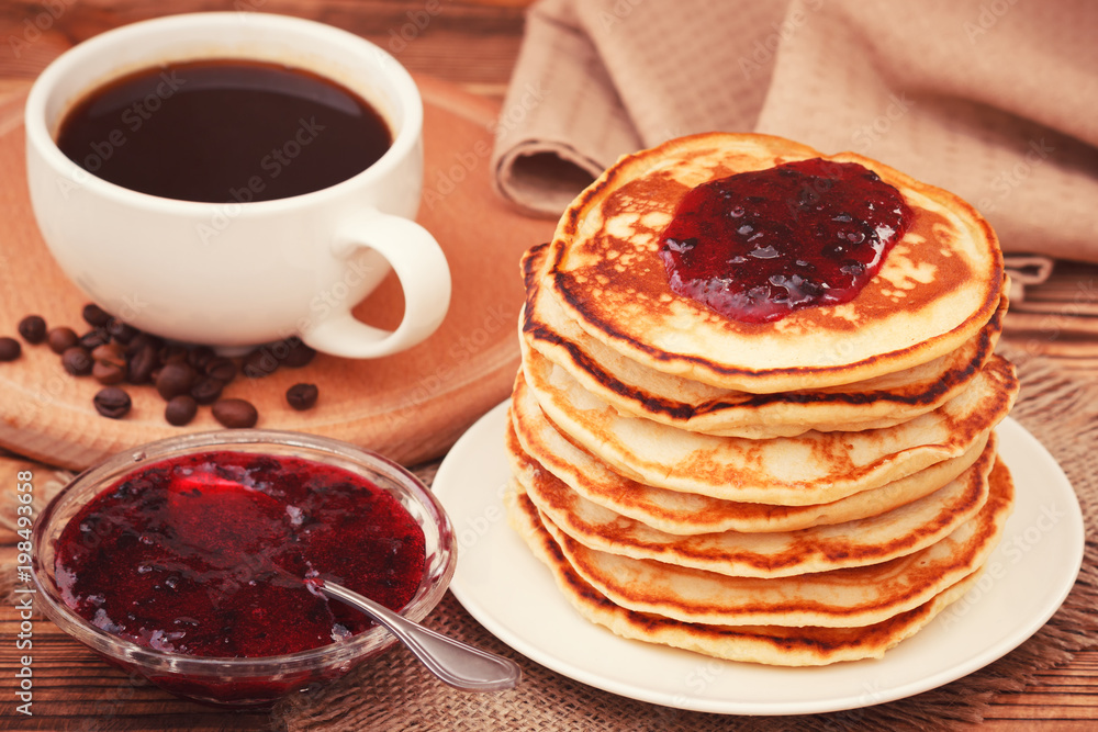 Homemade pancakes with black currant jam and coffee drink Homemade pancakes with black currant jam and coffee drink