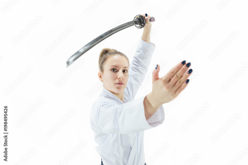 Aikido master practices defense posture. Healthy lifestyle and sports concept. Woman in white kimono on white background. Aikido master practices defense posture. Healthy lifestyle and sports concept. Woman in white kimono on white background.