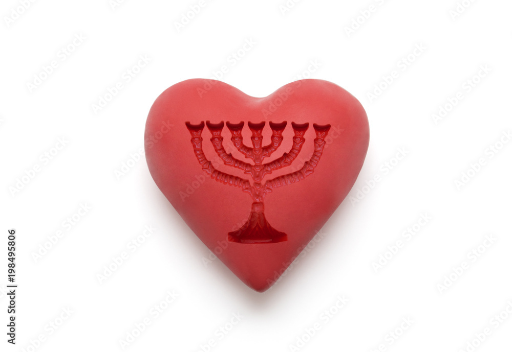 Red heart with imprinted menorah over white background with clipping path
