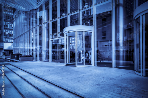 The entrance of the modern Enterprise Building, in the face view of the blue tone. © 昊 周