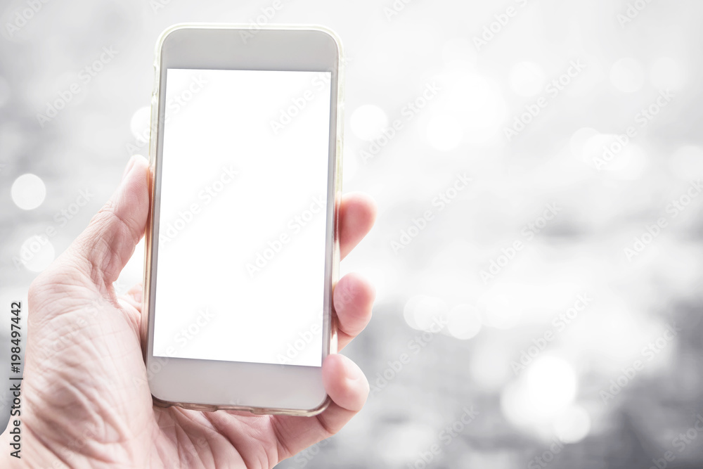 Blank white screen mobile on hand with blurred city light background. Business and technology background concept.