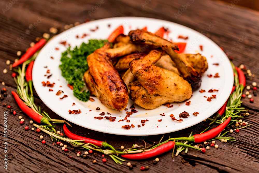 Chicken wings grilled with spices and chili pepper Chicken wings grilled with spices and chili pepper