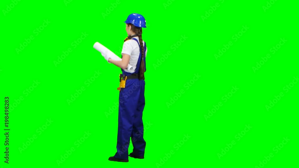 Engineer is standing and talking on the phone with a drawing in her hands. Green screen Engineer is standing and talking on the phone with a drawing in her hands. Green screen