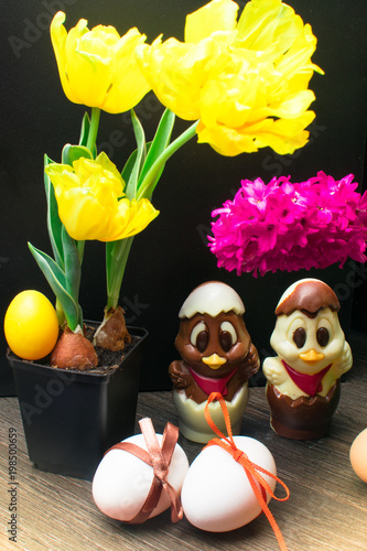 easter eggs with color ribbon and chocolate cute chicken decorated with flower - tulip and hyacinth photo