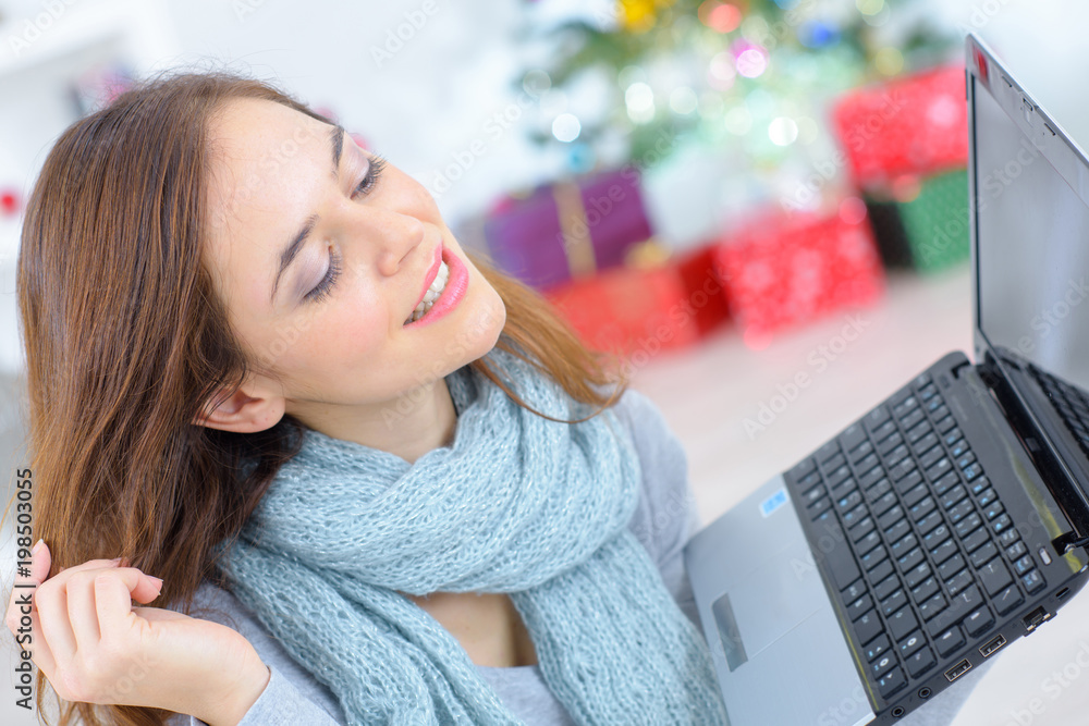 closeup of beautiful woman holding laptop at christmas closeup of beautiful woman holding laptop at christmas