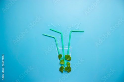 green cocktail on blue background photo