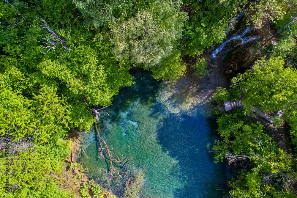beautiful waterfall and a small lake with green waters in Skra at north Greece beautiful waterfall and a small lake with green waters in Skra at north Greece