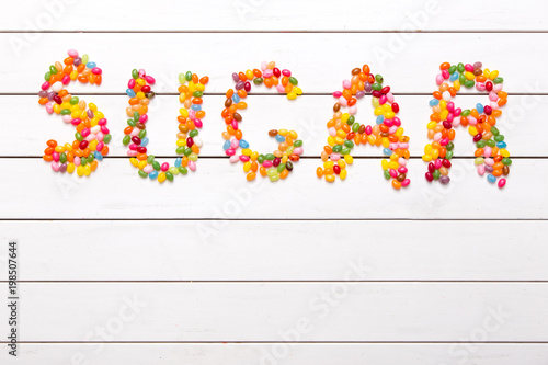 Colorful candy background with the word sugar