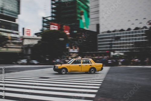 Taxi speeding across Shibuya crossing in Tokyo Japan
