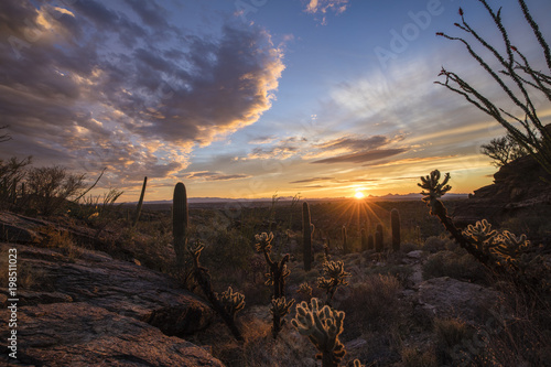 Colorful setting sun framed by rock formations. Tucson Arizona