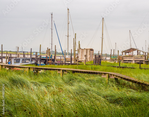 Derelict but stiil used wooden piers and sheds at Skipool Creek, Thornton Cleveleys, Lancashire, UK photo