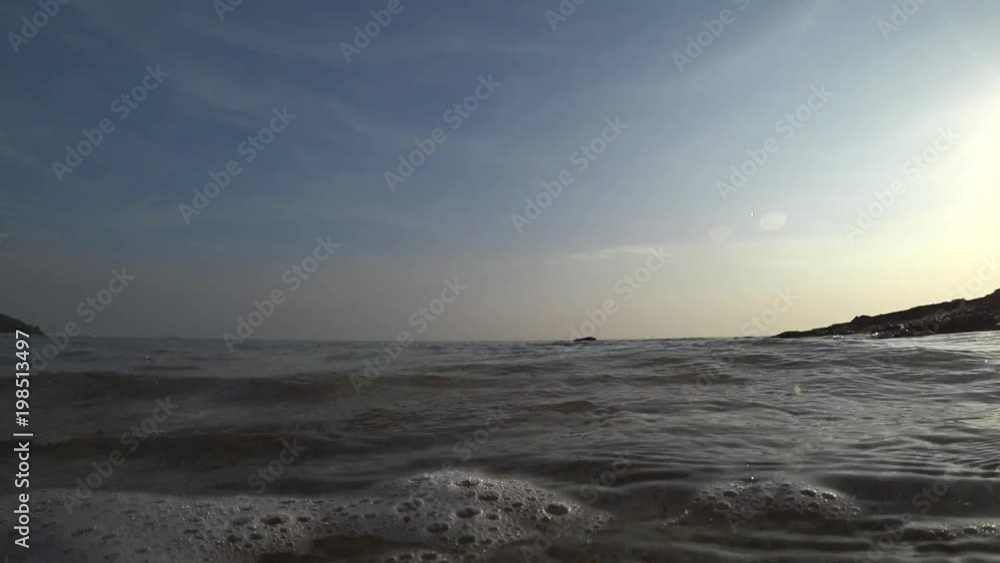 Beautiful low angle shot of the sea waves near shore splashes in camera. Beautiful low angle shot of the sea waves near shore splashes in camera.