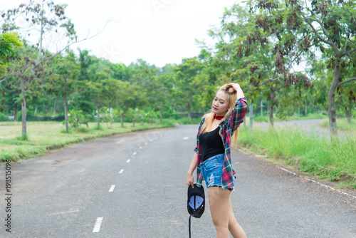 Asian hipsters girl posing for take a photo on the road,lifestyle of modern woman,Thai people in hippie style