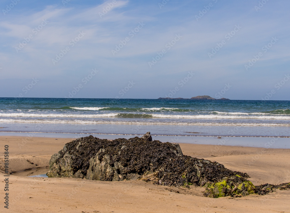 Attractive rock formations on the sandy beach at Whitesands Bay, St Davids Peninsular, Pembrokeshire, UK