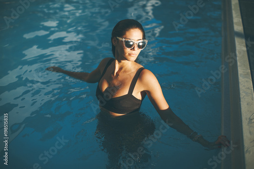 Young woman in the outdoor swimming pool