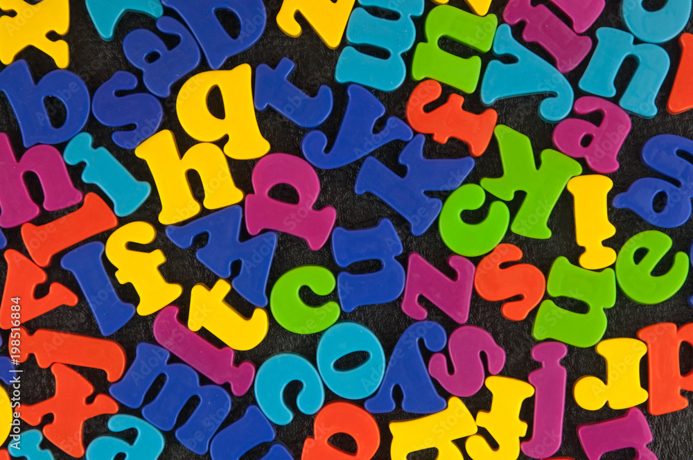Alphabet plastic letters on the leather background. Alphabet plastic letters on the leather background.