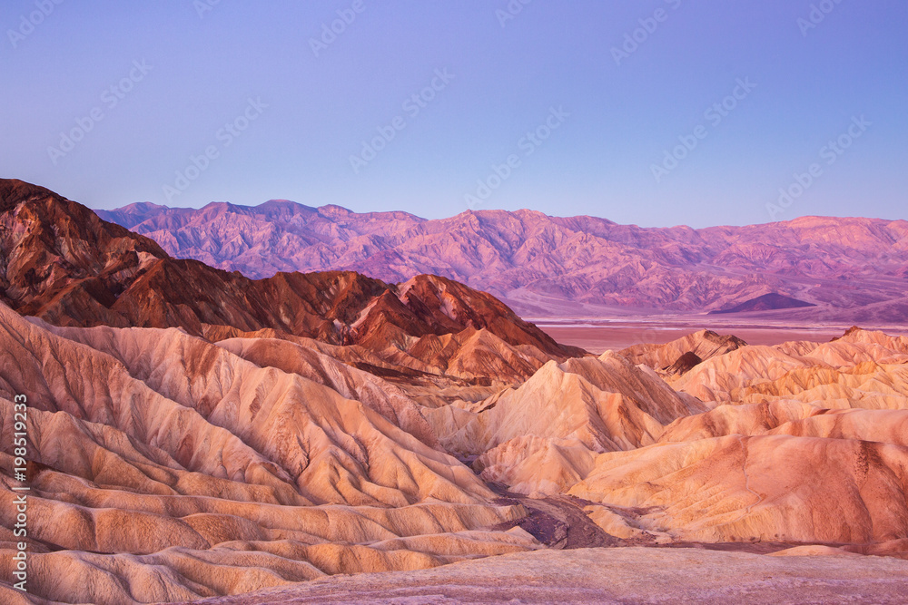  Scenic view from Zabriskie Point, showing convolutions,  color contrasts, and texture in the eroded rock at dawn, Amargosa Range, Death Valley in Death Valley National Park, United States.