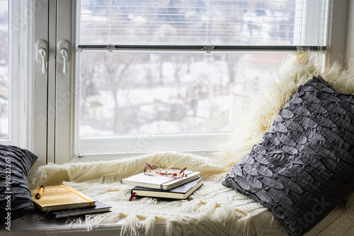 Slika na platnu Plaid, pillows, books, diaries on the window
