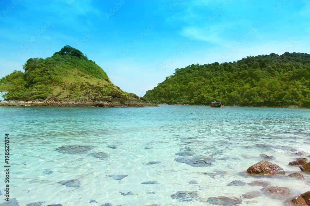 Fototapeta premium mountains and sea against a blue sky with clouds on a sunny day.