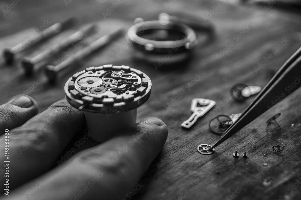 Watchmaker is repairing the mechanical watches in his workshop Watchmaker is repairing the mechanical watches in his workshop