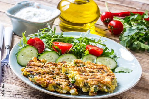 Juicy cutlets on a plate with a salad of tomatoes and arugula