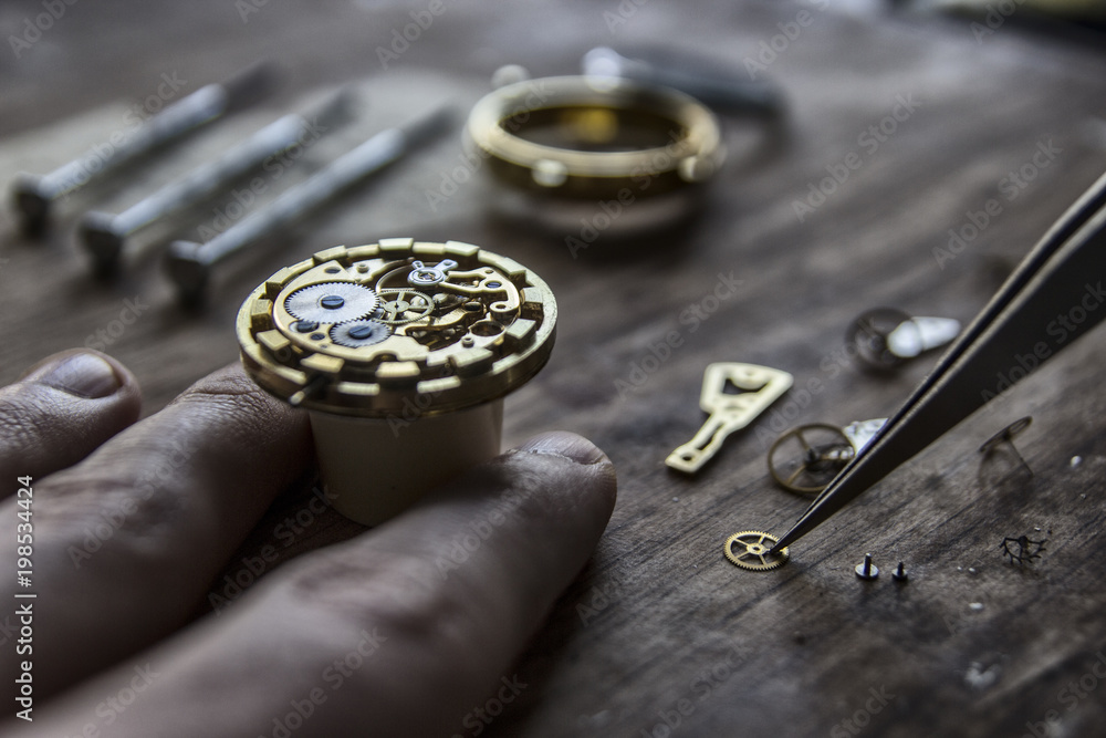 Watchmaker is repairing the mechanical watches in his workshop Watchmaker is repairing the mechanical watches in his workshop