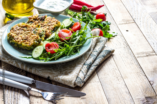 Juicy cutlets on a plate with a salad of tomatoes and arugula