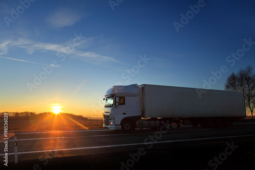 Truck transportation on the road at sunset