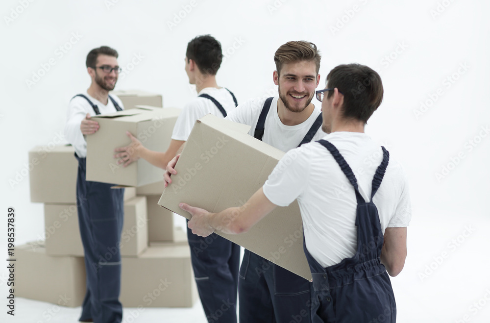 Portrait of movers holding box smiling isolated on white backgro Portrait of movers holding box smiling isolated on white backgro