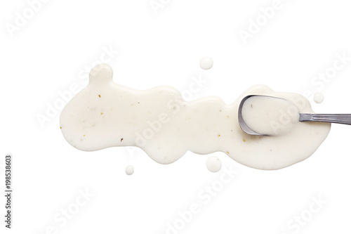 Foto splashes and spilled ranch dressing with a spoon