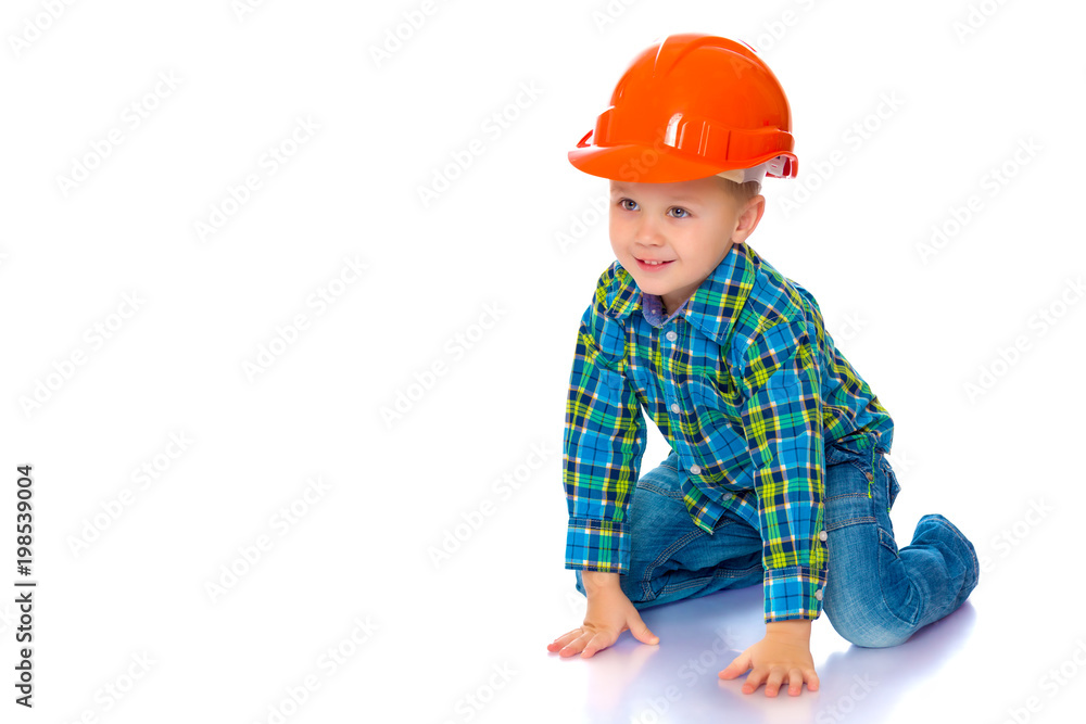 The little boy in the helmet of the builder. The little boy in the helmet of the builder.
