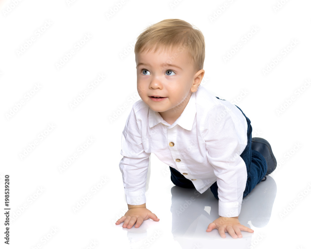 A little boy is lying on the floor in the studio. A little boy is lying on the floor in the studio.
