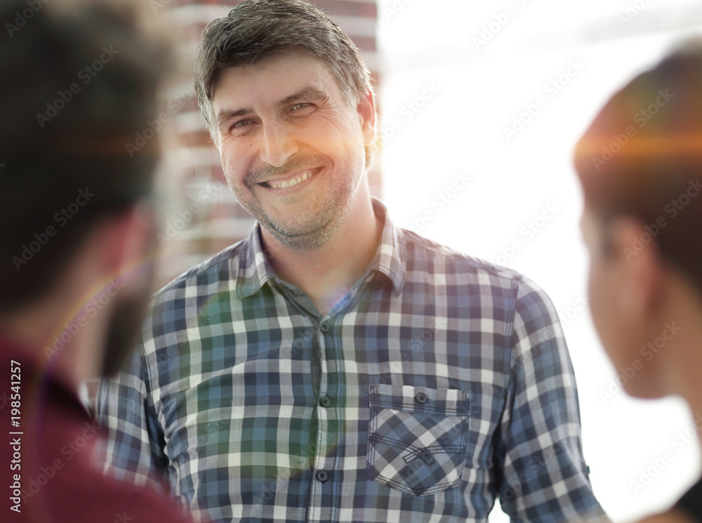 Portrait of confident businessman with colleagues, background Portrait of confident businessman with colleagues, background
